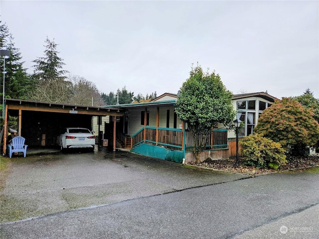 view of front of house with covered porch and a carport