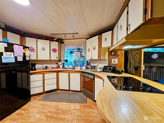 kitchen featuring black appliances, white cabinetry, a textured ceiling, and light hardwood / wood-style flooring