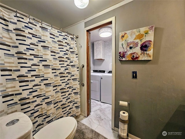 bathroom featuring separate washer and dryer and toilet