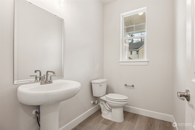 bathroom featuring hardwood / wood-style floors, toilet, and sink