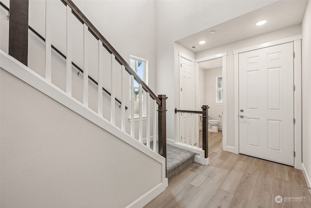 foyer entrance featuring a wealth of natural light and light hardwood / wood-style floors