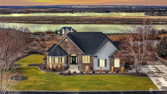 exterior space with a yard and a water view