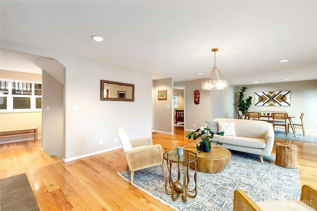 living room with a chandelier and light hardwood / wood-style floors