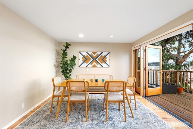 dining space with hardwood / wood-style floors