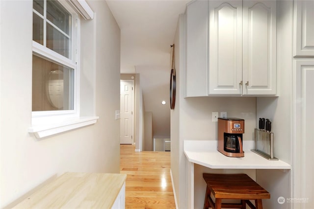 kitchen with white cabinets and light wood-type flooring