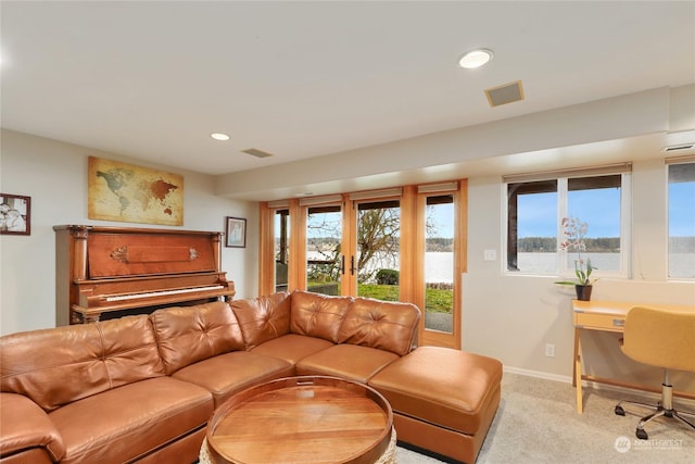 living room featuring french doors and light carpet