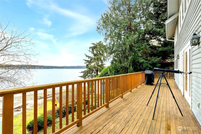 wooden deck featuring a water view