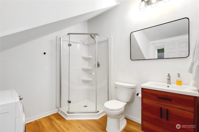 bathroom with washer and clothes dryer, hardwood / wood-style floors, and an enclosed shower