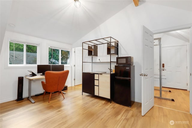 office featuring light hardwood / wood-style flooring and vaulted ceiling with beams