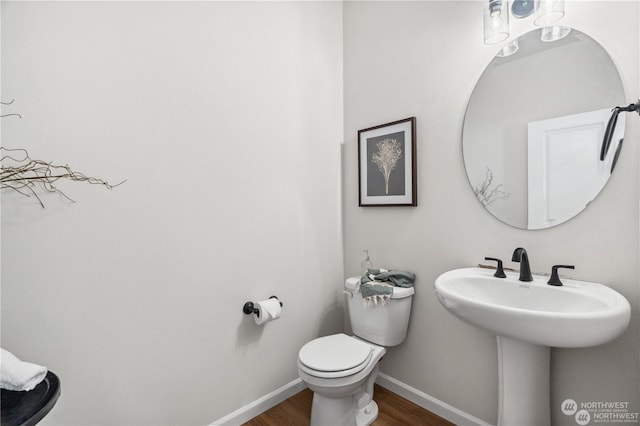 bathroom with hardwood / wood-style flooring and toilet