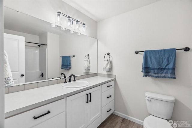 bathroom with vanity, wood-type flooring, toilet, and walk in shower