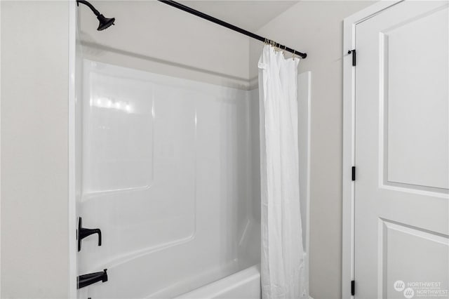 bathroom with shower / tub combo with curtain