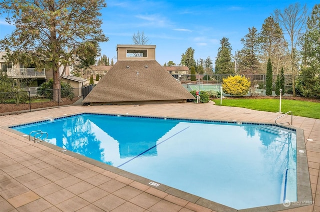 view of pool with a lawn