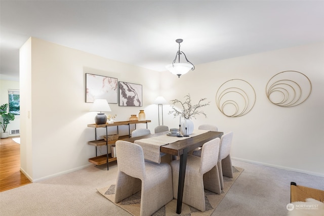 dining room featuring light colored carpet