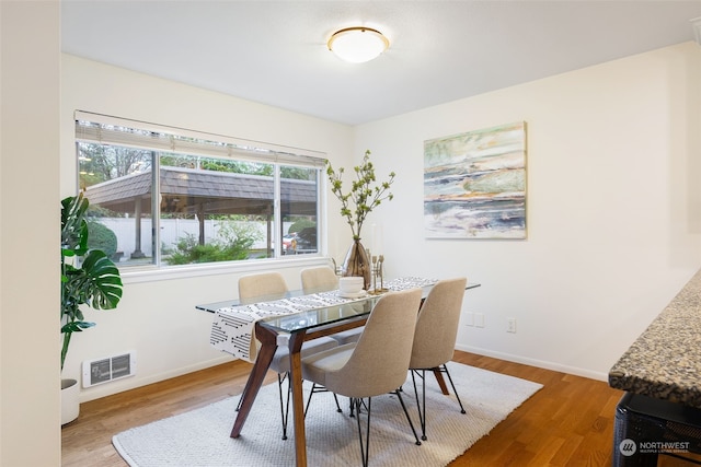 dining area with hardwood / wood-style floors