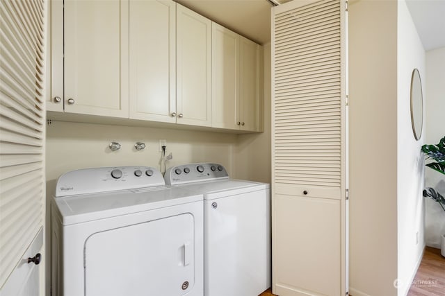 washroom with cabinets and independent washer and dryer