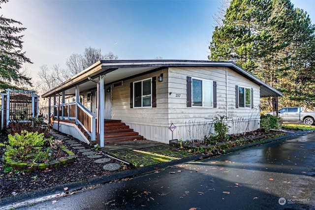 view of property exterior with covered porch