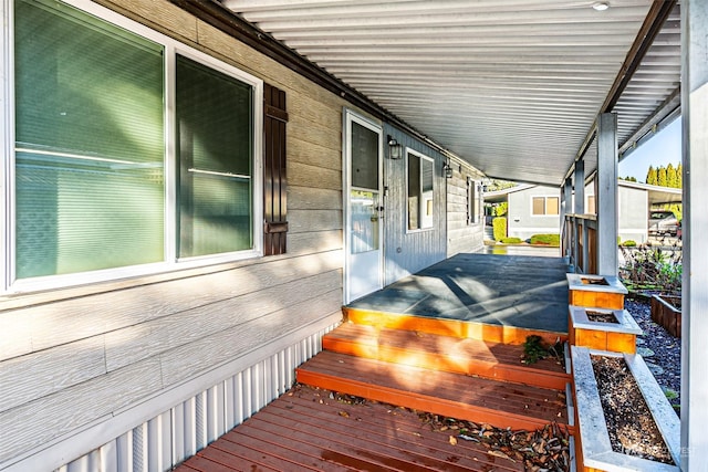 wooden terrace featuring covered porch