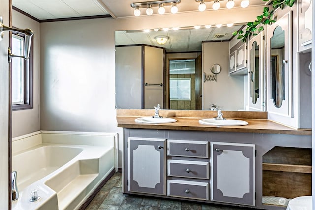 bathroom with a washtub, vanity, and crown molding