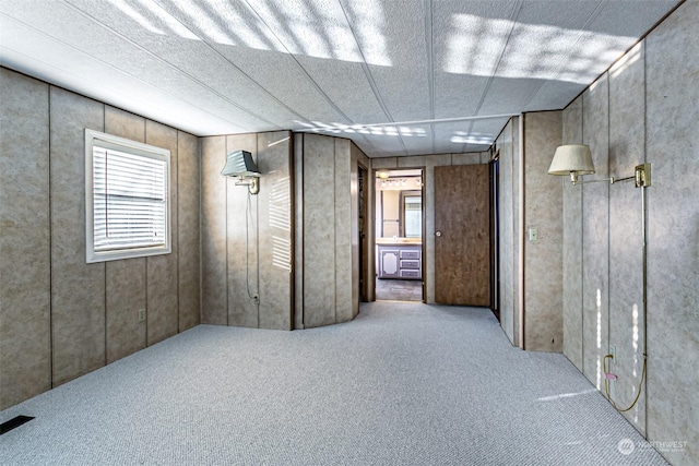 basement featuring light colored carpet