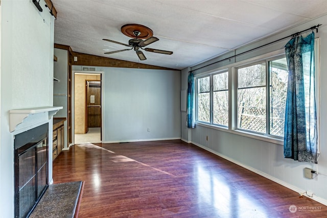 unfurnished living room featuring ceiling fan, a high end fireplace, dark wood-type flooring, and lofted ceiling