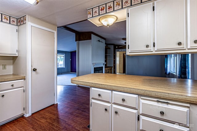 kitchen with white cabinets and dark wood-type flooring