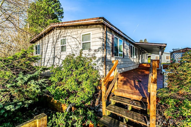 view of side of home featuring a wooden deck