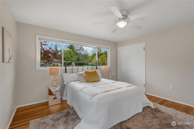 bedroom with ceiling fan and hardwood / wood-style floors