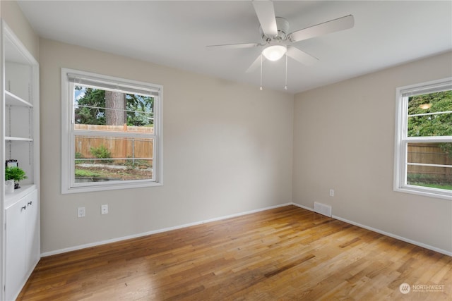 unfurnished room featuring ceiling fan and light hardwood / wood-style floors