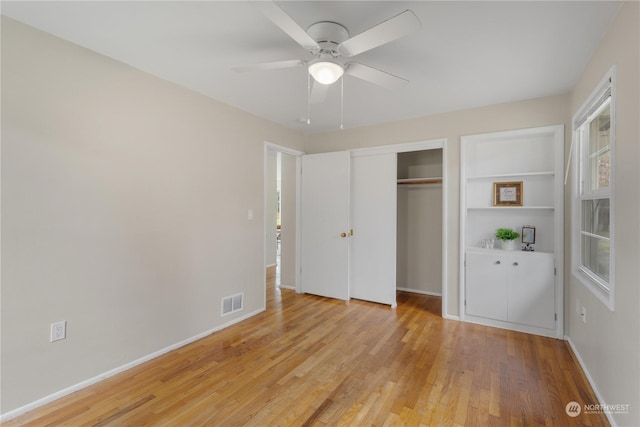 unfurnished bedroom featuring ceiling fan, a closet, and light hardwood / wood-style flooring