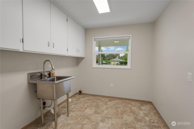 laundry area with cabinets