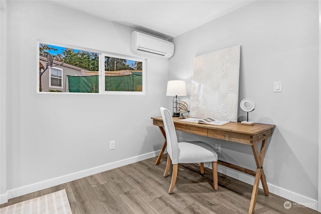 home office featuring hardwood / wood-style flooring and a wall unit AC