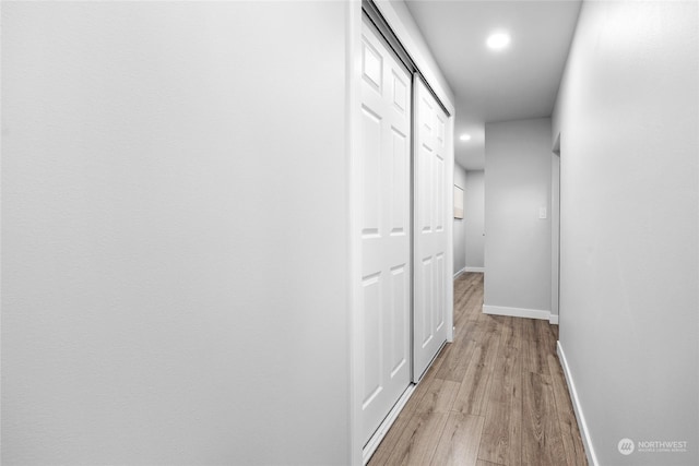 hall with light hardwood / wood-style floors