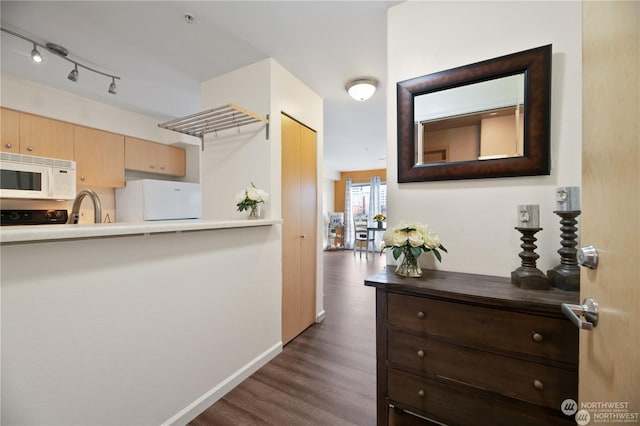 kitchen with sink, dark wood-type flooring, and white appliances