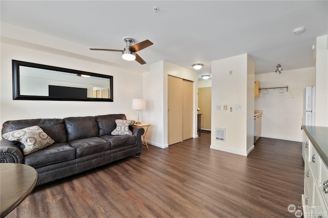 living room with dark hardwood / wood-style floors and ceiling fan