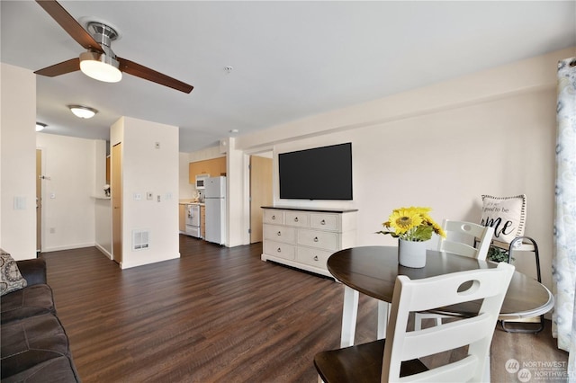 living room featuring ceiling fan and dark wood-type flooring