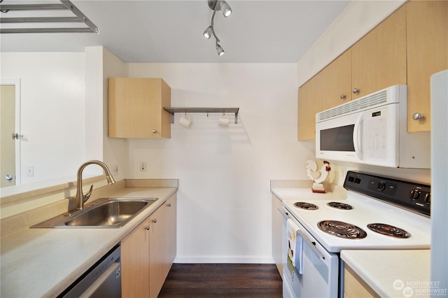 kitchen with light brown cabinetry, sink, dark wood-type flooring, and white appliances