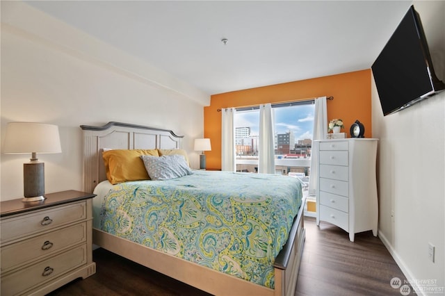 bedroom with dark hardwood / wood-style flooring