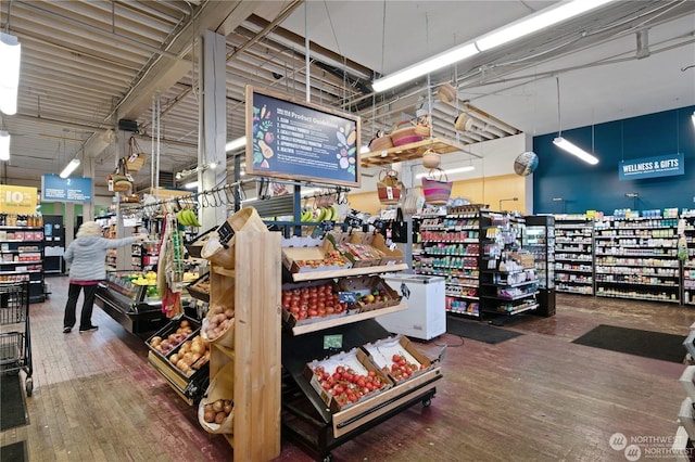 interior space featuring a towering ceiling and wood-type flooring