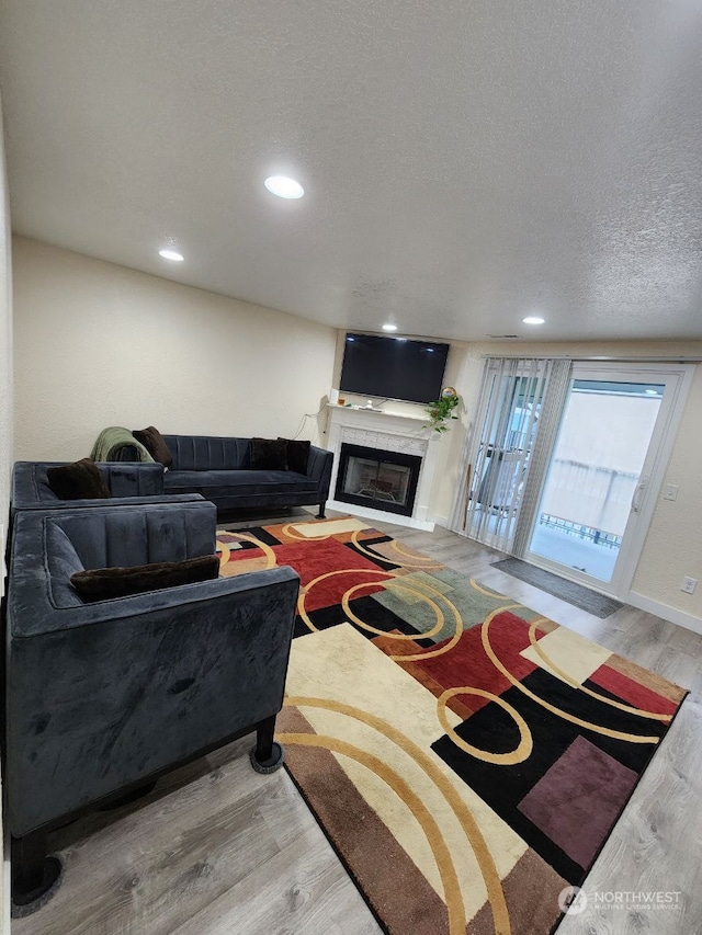 living room featuring hardwood / wood-style flooring and a textured ceiling