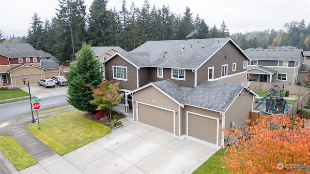 view of front of house featuring a front lawn and a garage