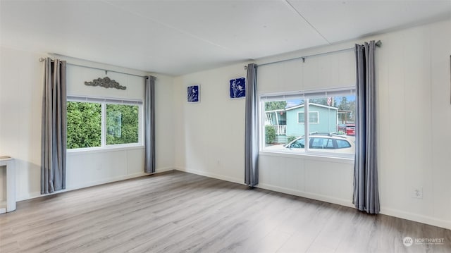 spare room with light hardwood / wood-style flooring