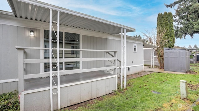 view of side of property with a lawn and a shed