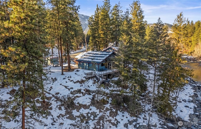 snowy aerial view featuring a mountain view