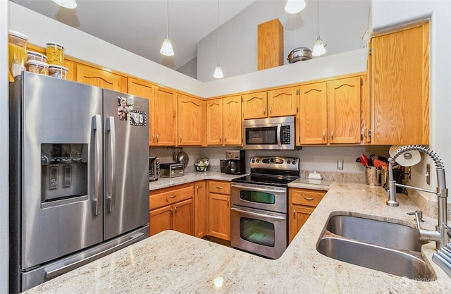 kitchen with kitchen peninsula, stainless steel appliances, sink, decorative light fixtures, and lofted ceiling