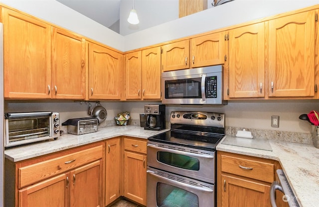 kitchen featuring light stone counters and appliances with stainless steel finishes