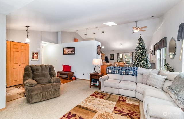 living room featuring ceiling fan, carpet floors, and high vaulted ceiling