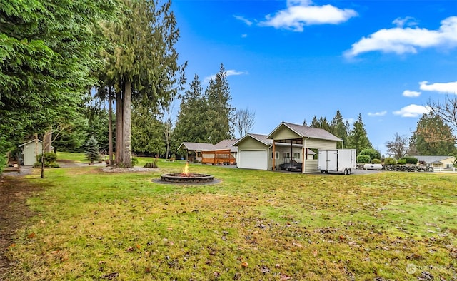 view of yard with an outdoor fire pit