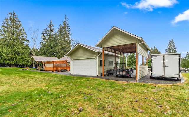 back of property featuring a carport, an outdoor structure, and a yard