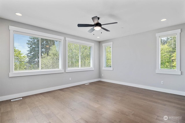 unfurnished room with hardwood / wood-style flooring and ceiling fan